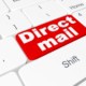 Bright red key that says direct mail on a white keyboard