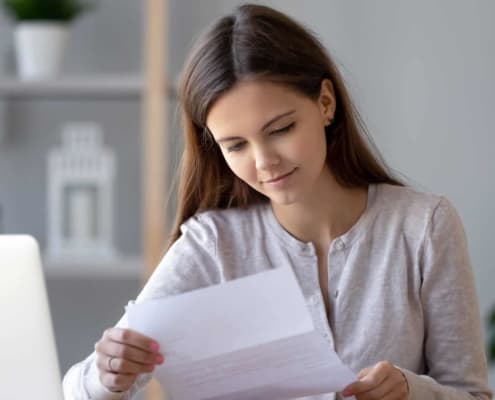 Woman looking at medical paper from the mail