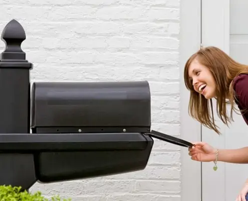 Woman looking into mailbox for mail