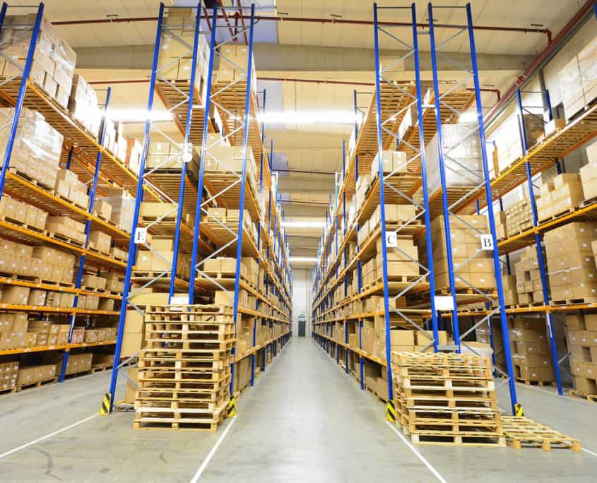 Interior view of a warehouse with tall blue shelves