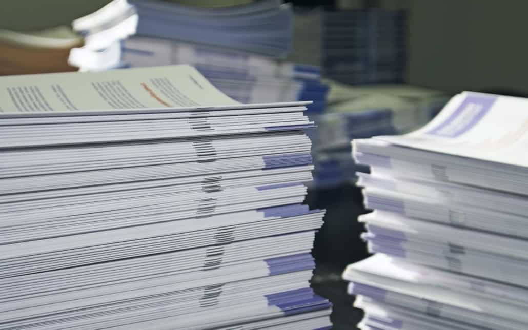 Close up view of stacks of flyers and paper
