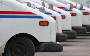 Postal trucks in a line in a parking lot
