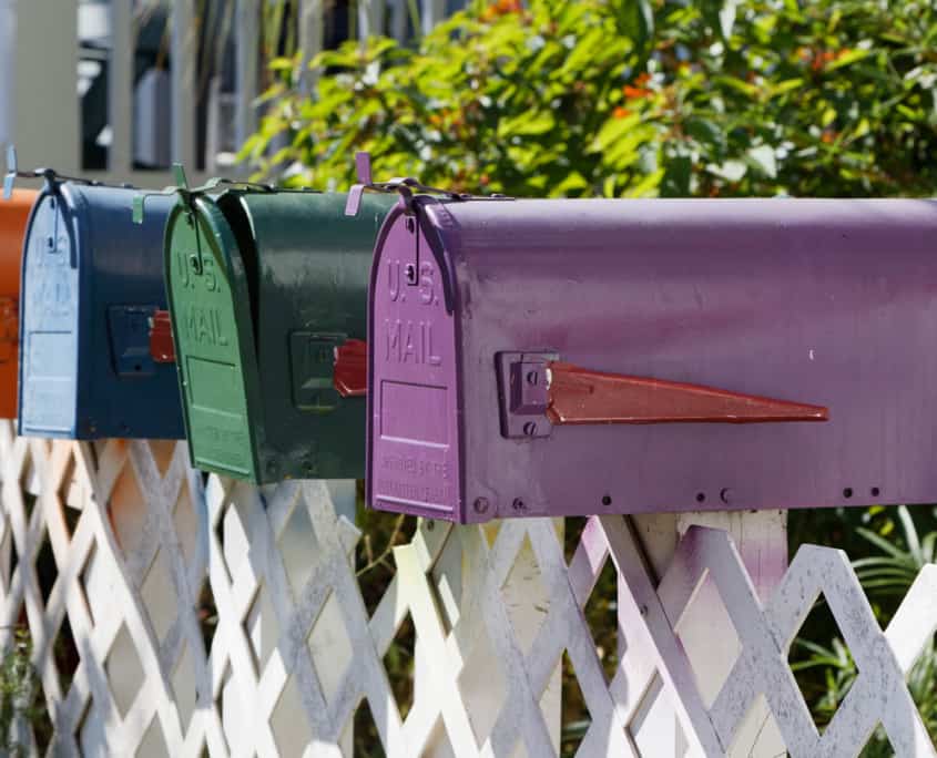 Side view of multi colored mail boxes