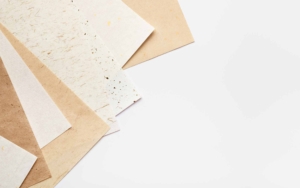 Stack of different handmade paper on a white background