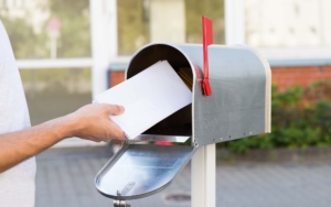 Person Putting Letters In Mailbox_