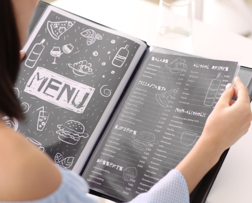 Image of a person looking at a restaurant menu.