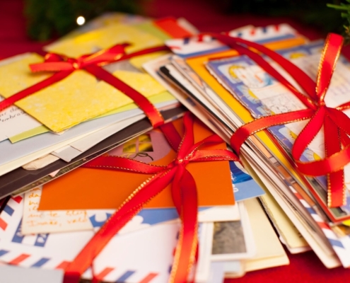 Side view of multiple bunches of holiday cards