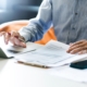 Business person looking over printed statement