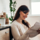 Portrait of a beautiful woman checking mail at home