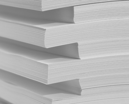 Several stacks of white paper on a white background