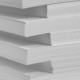 Several stacks of white paper on a white background