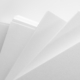 Several stacks of white paper on a white background