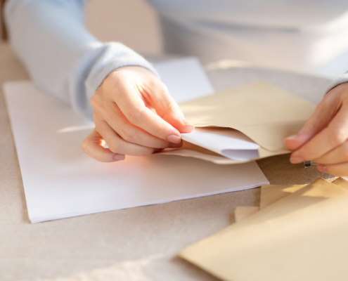 Woman in grey outfit sitting at the table